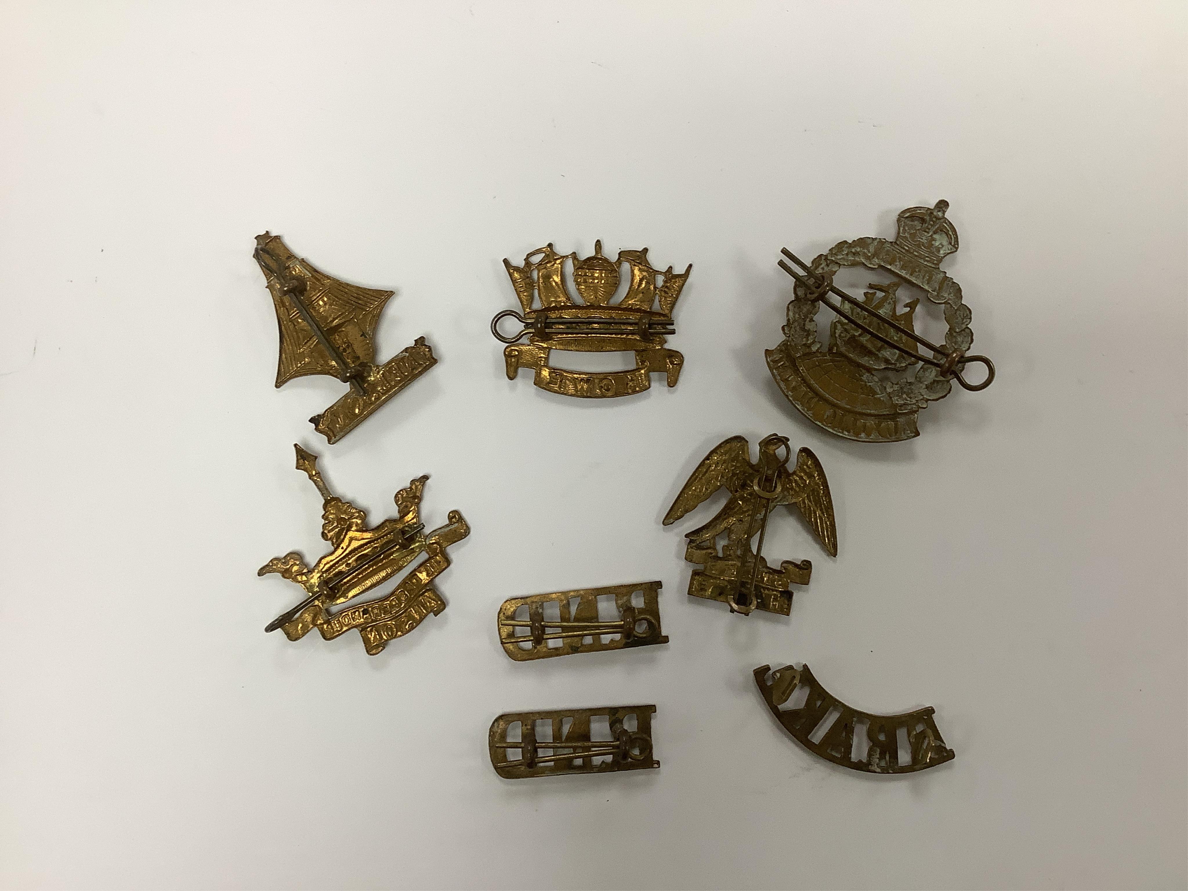 Five Royal Navy First World War brass cap badges; the Nelson, Hawke, Anson and Howe Battalions, together with three shoulder titles. Condition - fair, some possible restrikes.